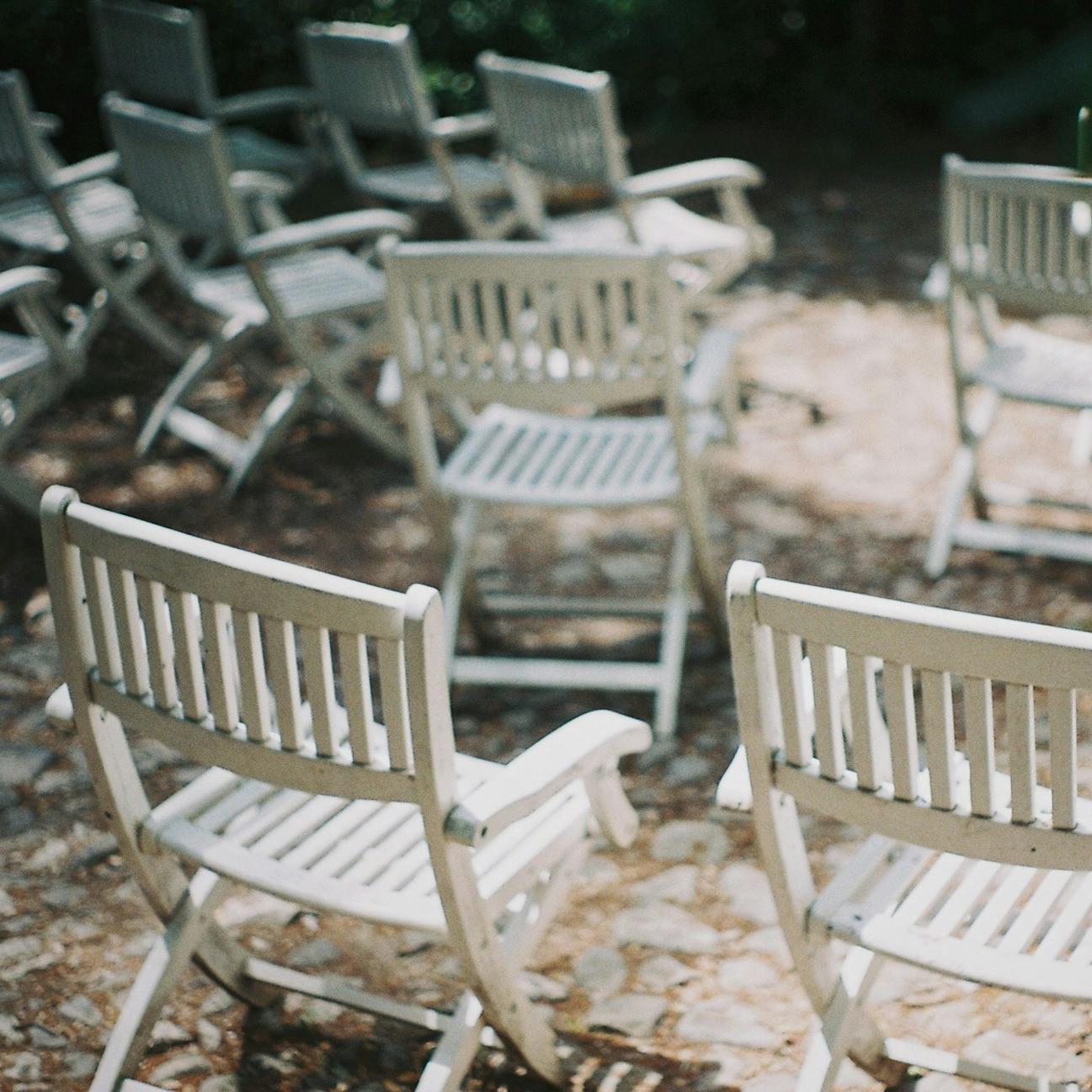 empty white wooden folding chairs
